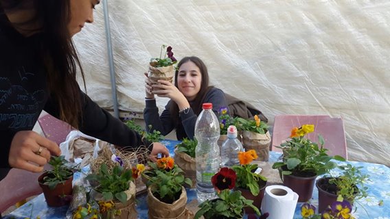 Image may contain: 1 person, flower, drink, food and indoor